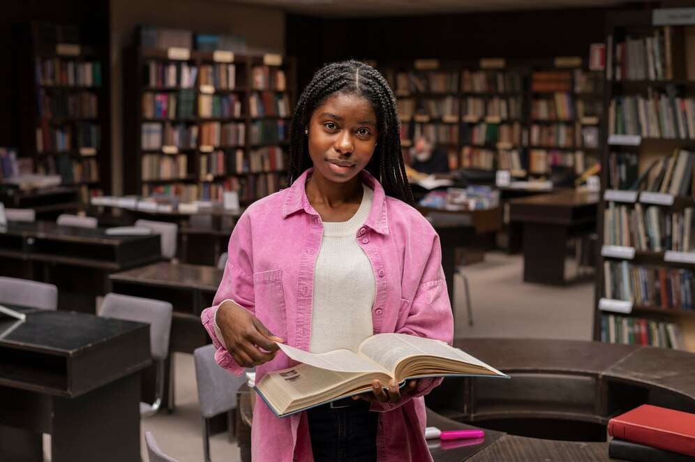 black graduate in library